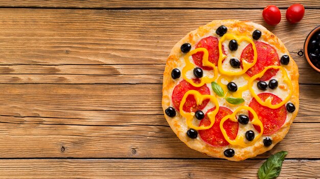 Delicious pizza on wooden table with copy space