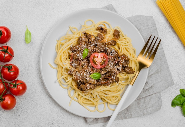 Delicious plate with spaghetii bolognese on desk