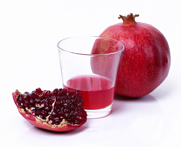 Delicious pomegranate and juice on white