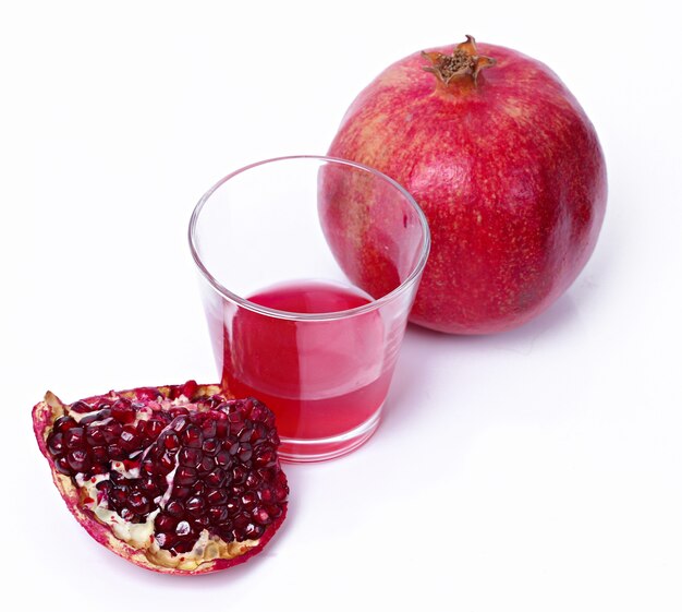 Delicious pomegranate and juice on white