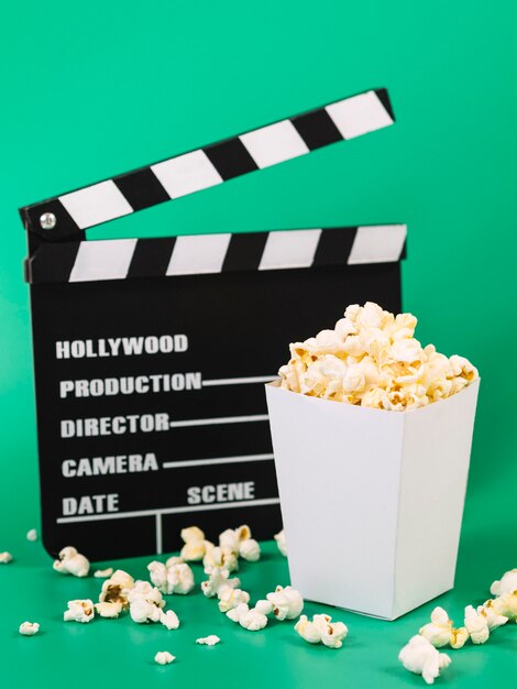 Delicious popcorn box with movie clapperboard