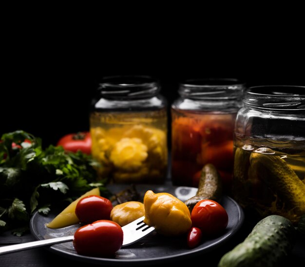 Delicious preserved vegetables on plate