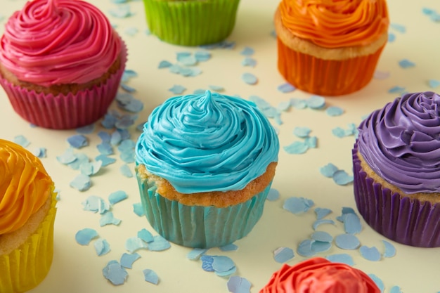 Delicious rainbow cupcakes still life