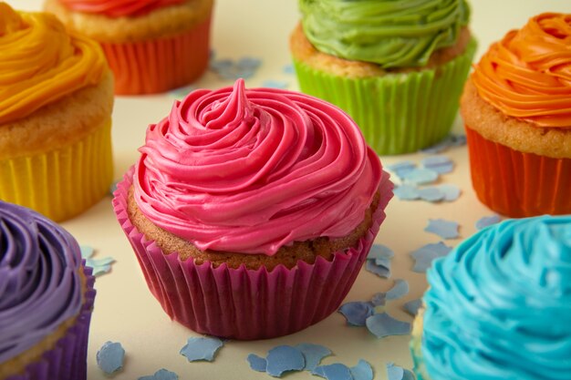 Delicious rainbow cupcakes still life