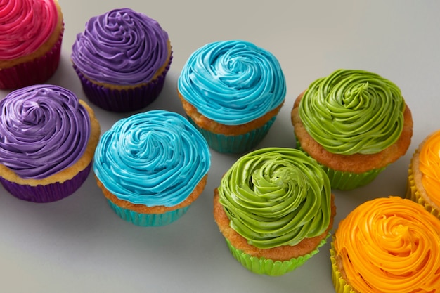 Free photo delicious rainbow cupcakes still life