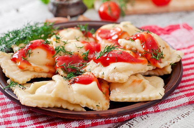 Delicious ravioli with tomato sauce and dill