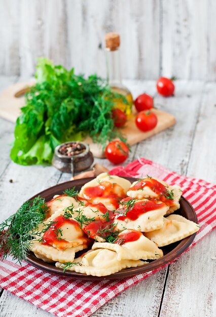 Delicious ravioli with tomato sauce and dill