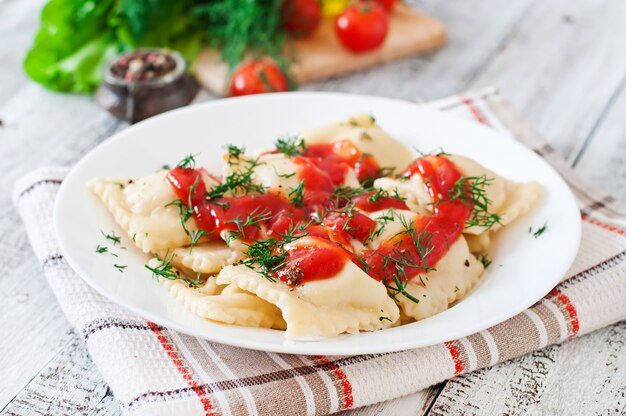 Delicious ravioli with tomato sauce and dill