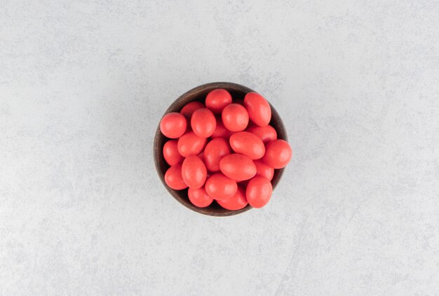 Delicious red gums in the bowl on the marble surface