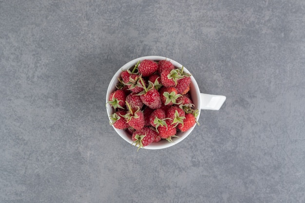Delicious red strawberries in white mug. High quality photo