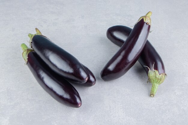 Delicious ripe eggplants, on the white surface