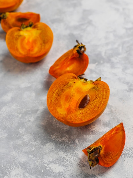 Delicious ripe persimmon fruit on concrete 