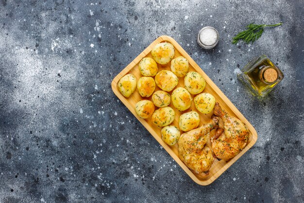 Delicious roasted young potatoes with dill and chicken, top view