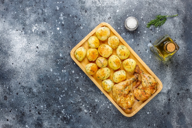 Delicious roasted young potatoes with dill and chicken, top view