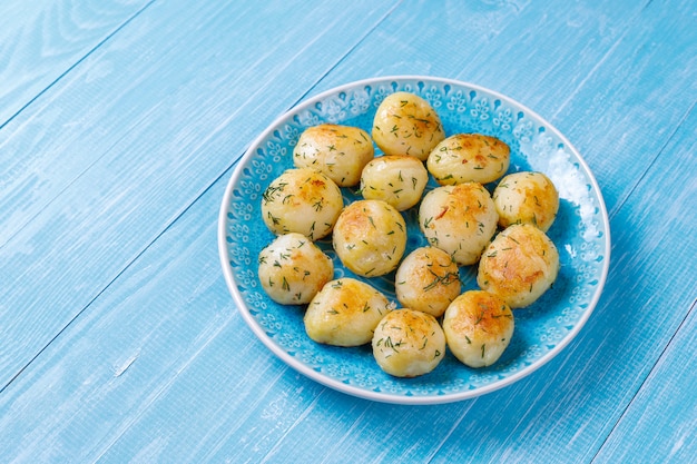 Delicious roasted young potatoes with dill, top view