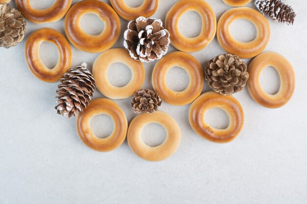 Delicious round cookies with pinecones on white background. High quality photo