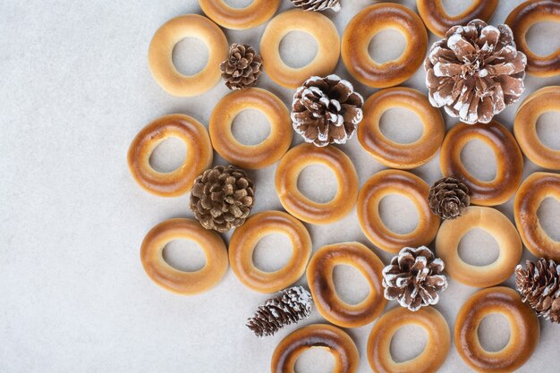 Delicious round cookies with pinecones on white background. High quality photo