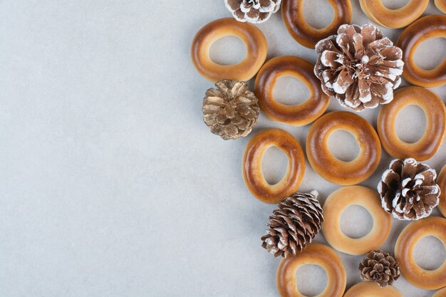 Delicious round cookies with pinecones on white background. High quality photo