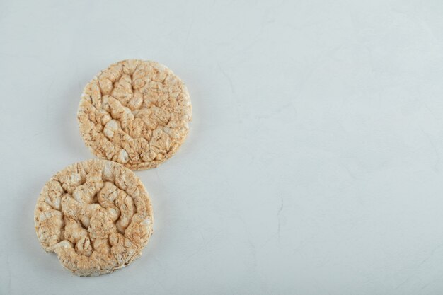 Delicious round crispbread on gray surface