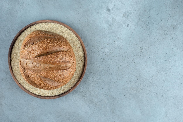 Foto gratuita panino di segale delizioso sul piatto di legno.