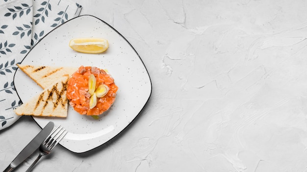 Delicious salmon appetizer flat lay