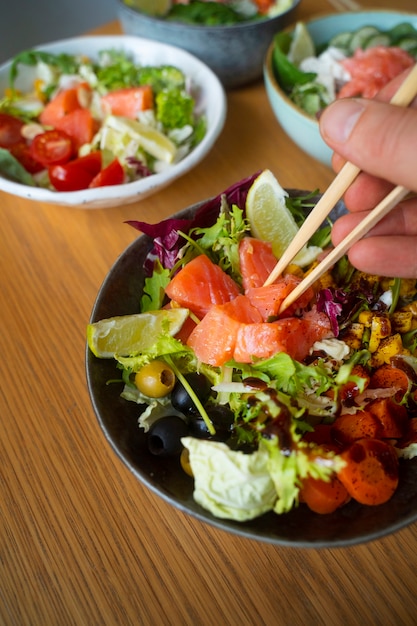 Delicious salmon bowls on table arrangement