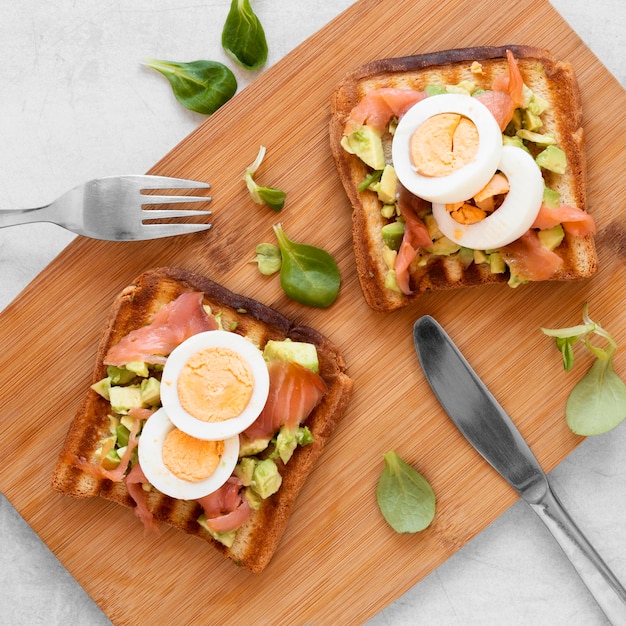 Delicious sandwiches on wooden board