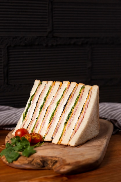 Delicious sandwiches on wooden board