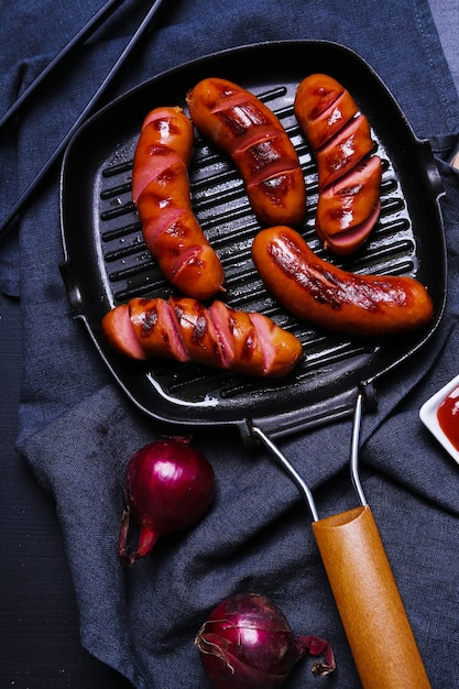 Free photo delicious sausages on frying pan