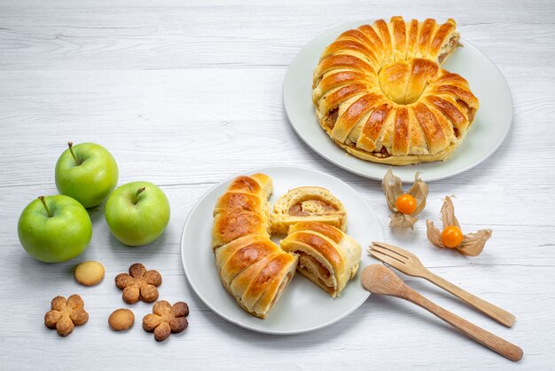 delicious sliced pastries inside plate with filling along with green apples and cookies on white desk, pastry cookie biscuit sweet sugar