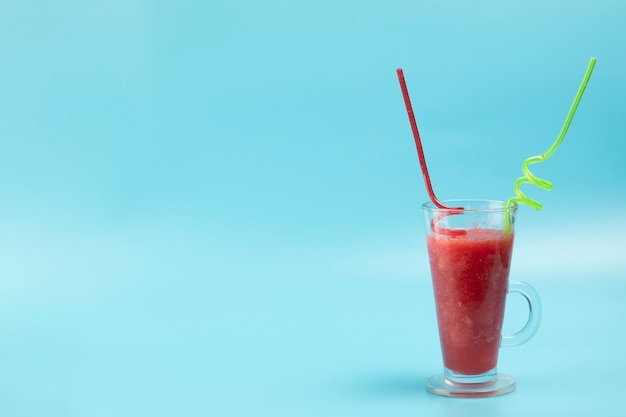 Delicious smoothie on blue background with copy space