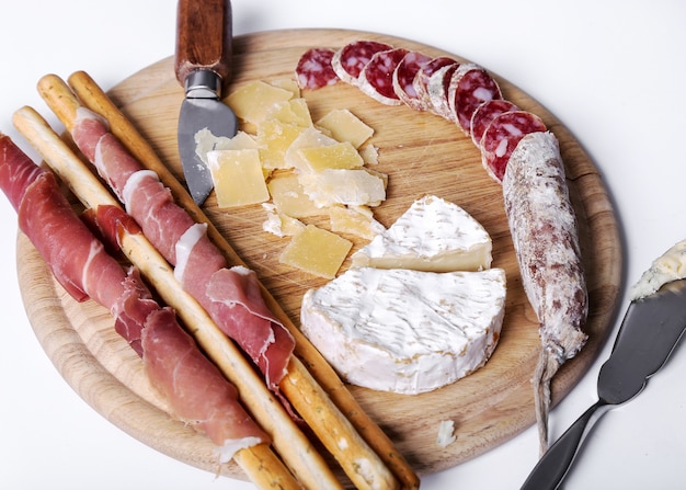 Delicious snacks on wooden board