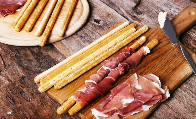 Delicious snacks on wooden board