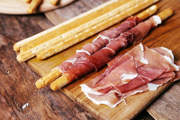 Delicious snacks on wooden board