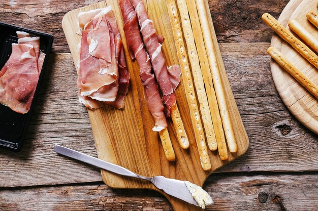 Delicious snacks on wooden board