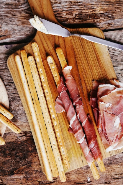 Delicious snacks on wooden board