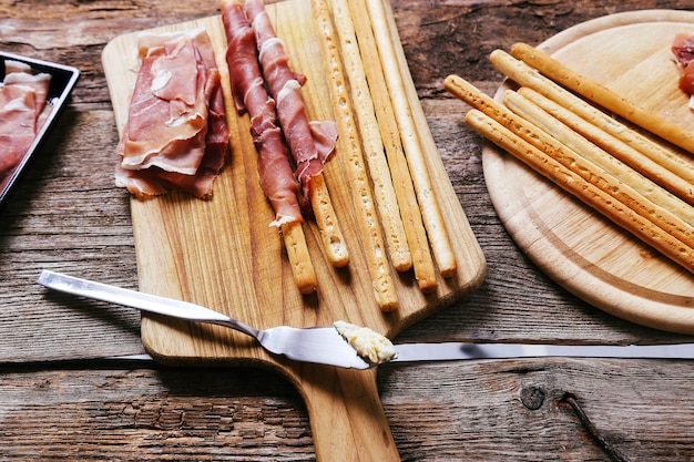 Delicious snacks on wooden board