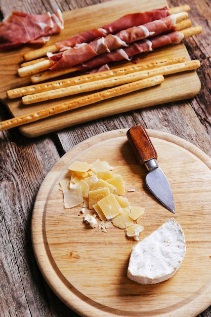 Delicious snacks on wooden board