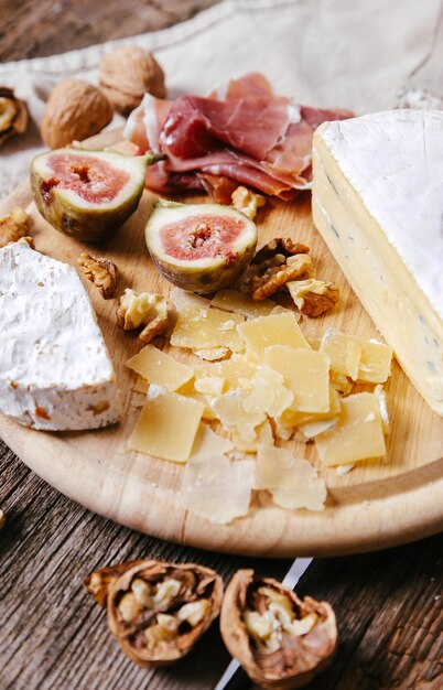 Delicious snacks on wooden board