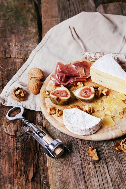 Delicious snacks on wooden board