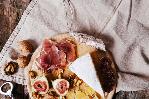 Delicious snacks on wooden board