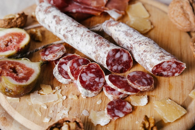 Delicious snacks on wooden board