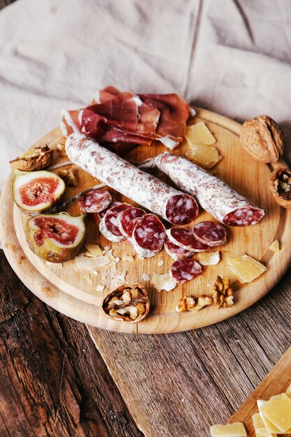 Delicious snacks on wooden board