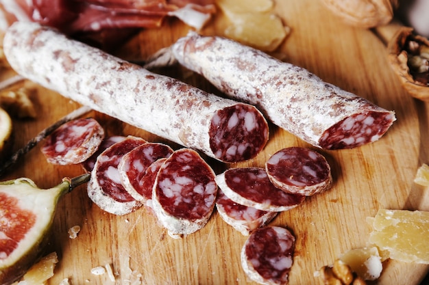 Delicious snacks on wooden board