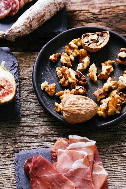 Delicious snacks on wooden board