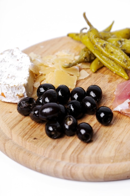 Delicious snacks on wooden board