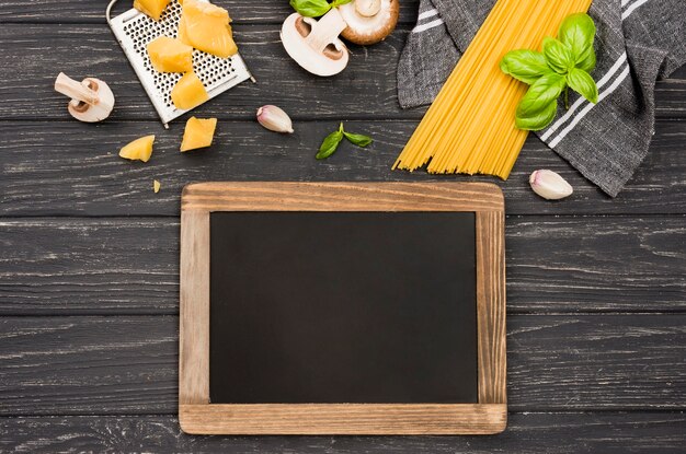 Delicious spaghetti with mushrooms beside chalkboard