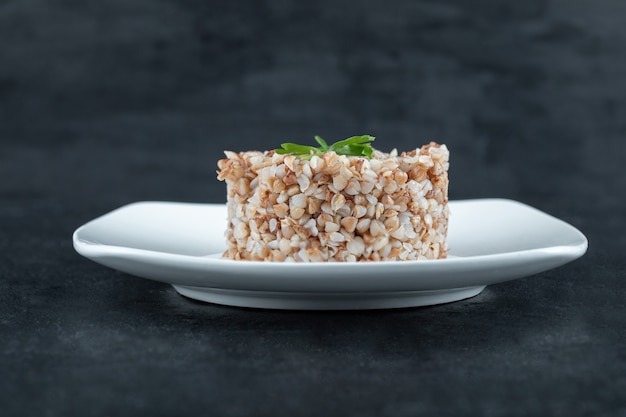 Delicious steamed buckwheat on white surface