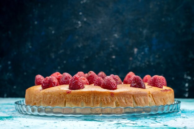delicious strawberry cake round shaped with fruits on top on bright-blue , cake dough sweet biscuit sugar fruit berry