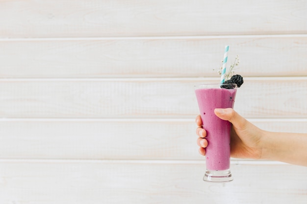 Delicious summer smoothie in hand